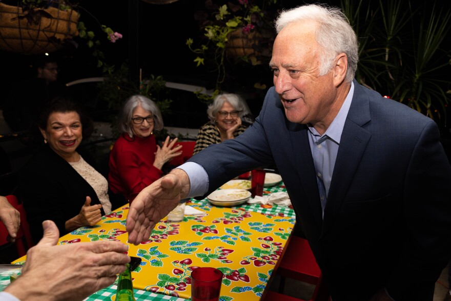 Kirk Watson shaking hands with watch party attendee at Santa Rita Cantina on Dec. 13, 2022
