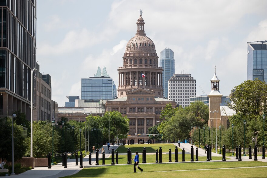 Pedestrians walk along the new Capitol Mall, a green pedestrian space running down Congress Avenue from the Blanton Museum to the Texas State Capitol Building, on May 3, 2023, in downtown Austin.