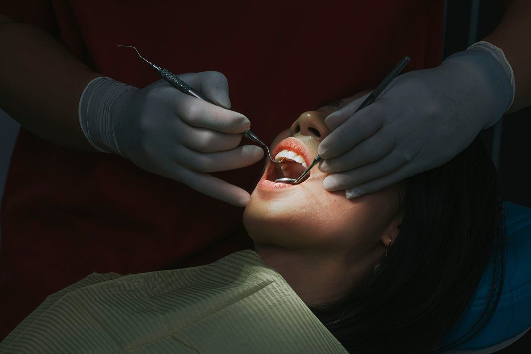 close up of a female patient with open mouth during a dental check up.