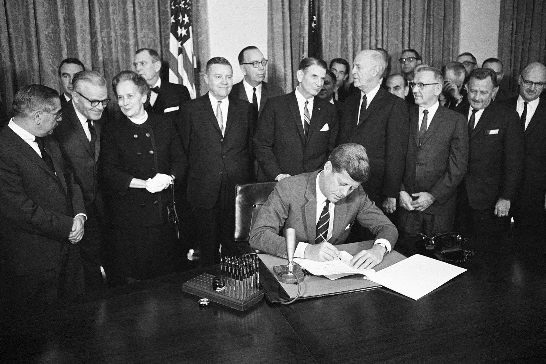 President John F. Kennedy signs a bill for mental health programs at the White House.