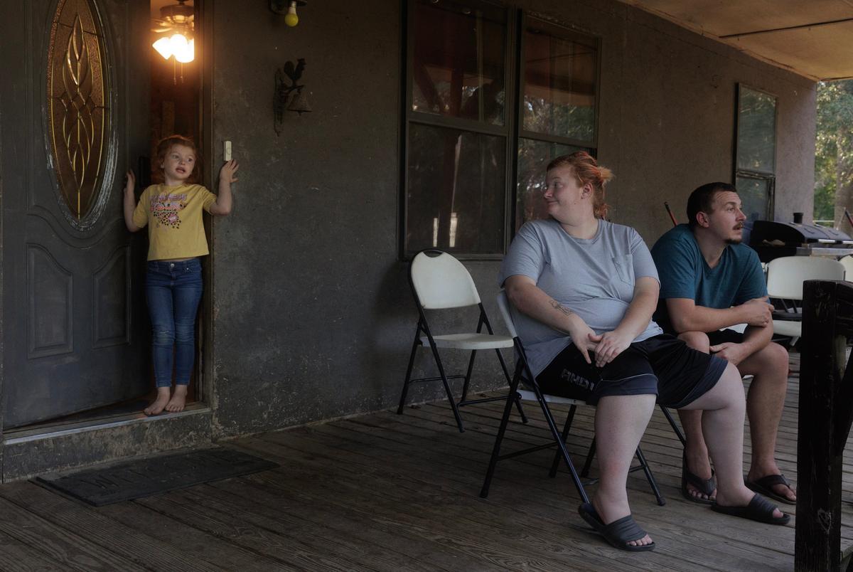 Artemis, 4, asks her mother Miranda Michel to come inside and play with her at Michel’s mother-in-law’s house in Broken Bow, Oklahoma on August 17, 2023.