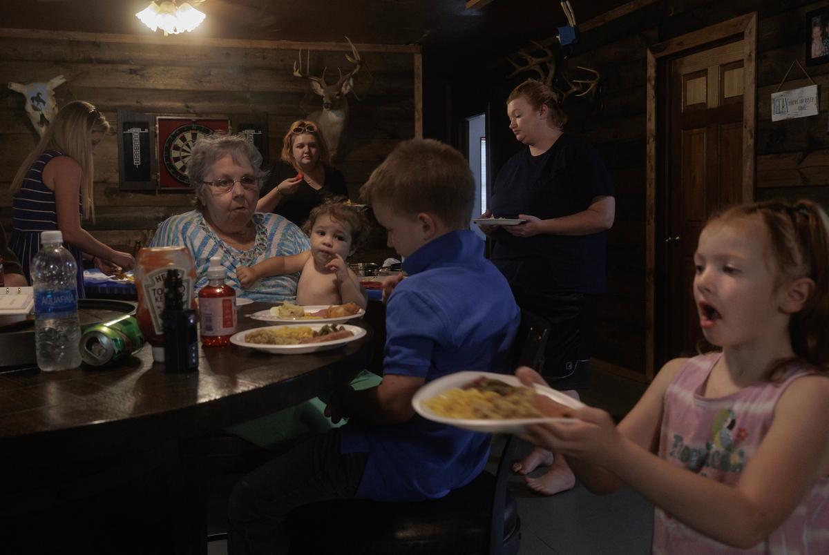 Michel’s family serves themselves plates of ham, mac and cheese, mashed potatoes and green beans following the funeral service and burial in Broken Bow, Oklahoma on August 18, 2023.
