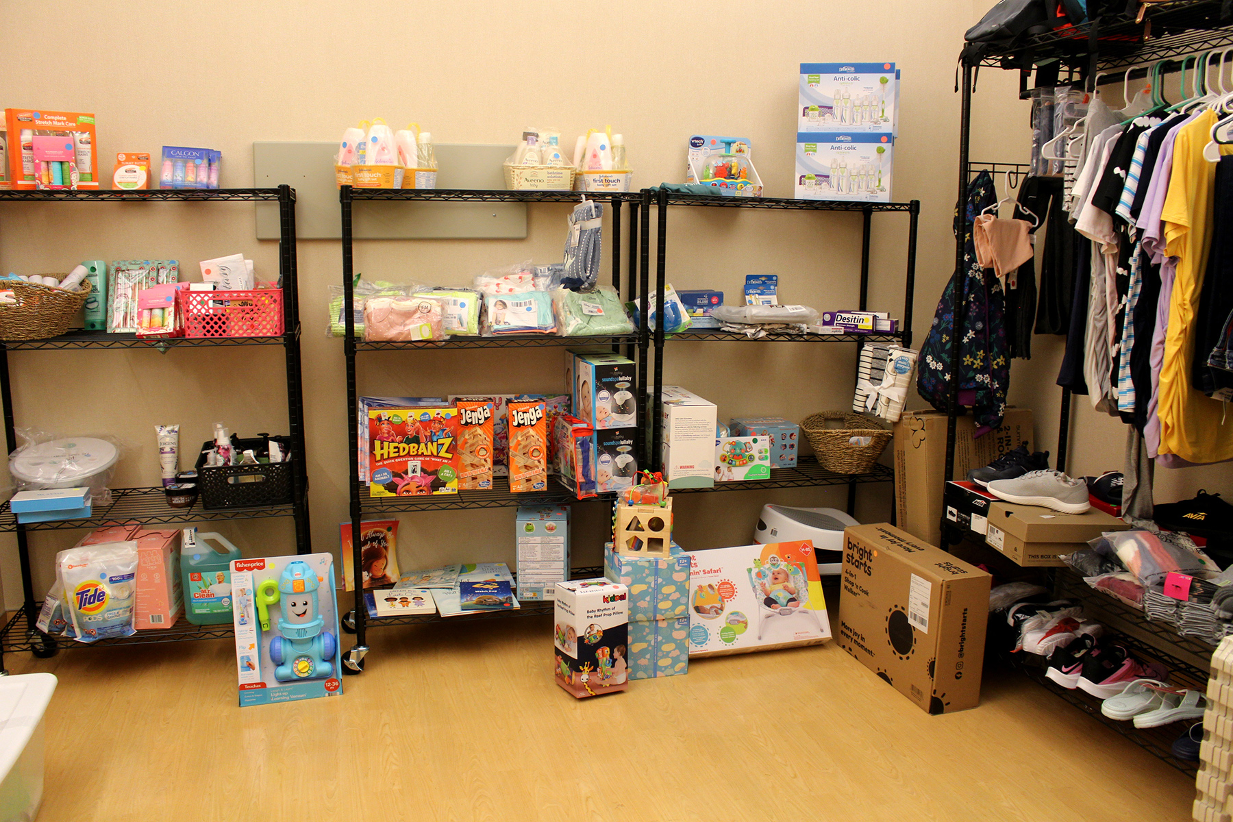 Racks full of women's and babies’ clothing, shoes, toys and more.