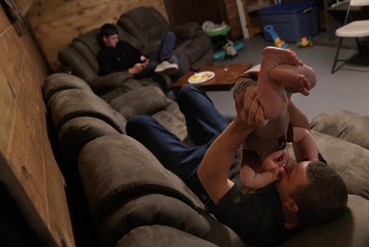 Levi Langley plays with his 9-month-old son Eros at his mother’s home in Broken Bow, Oklahoma on August 18, 2023.
