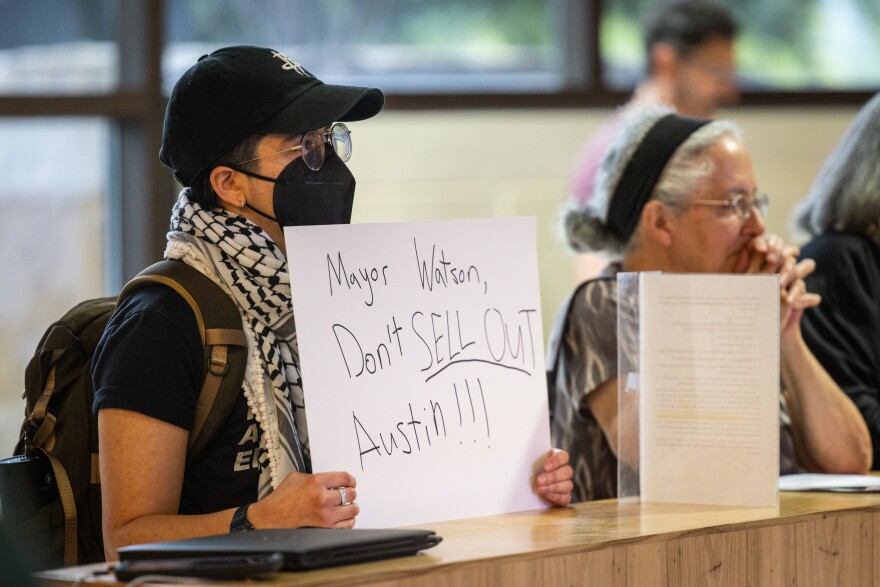 An audience member holds a sign reading “Mayor Watson, Don’t Sell Out Austin!” as Austin City Council hears public comments before voting on HOME Phase 2 on May 16, 2024, at Austin City Hall. Michael Minasi/KUT News